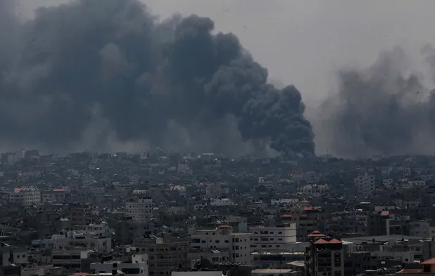 Smoke rises after an Israeli missile hit Shajaiyeh neighborhood in Gaza City, northern Gaza Strip, Sunday, July 20, 2014. Hundreds of panicked residents have fled the neighborhood which they say has come under heavy tank fire from Israeli forces. Some reported seeing dead and wounded in the streets, with ambulances unable to reach the area. Israel widened its ground offensive early Sunday, sending more troops into the Hamas-ruled territory to destroy tunnels used by the Islamic militants to try to sneak into Israel.  Photo by Ashraf Amra